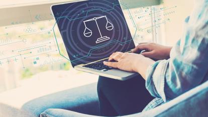 Justice theme with woman using her laptop in her home office
